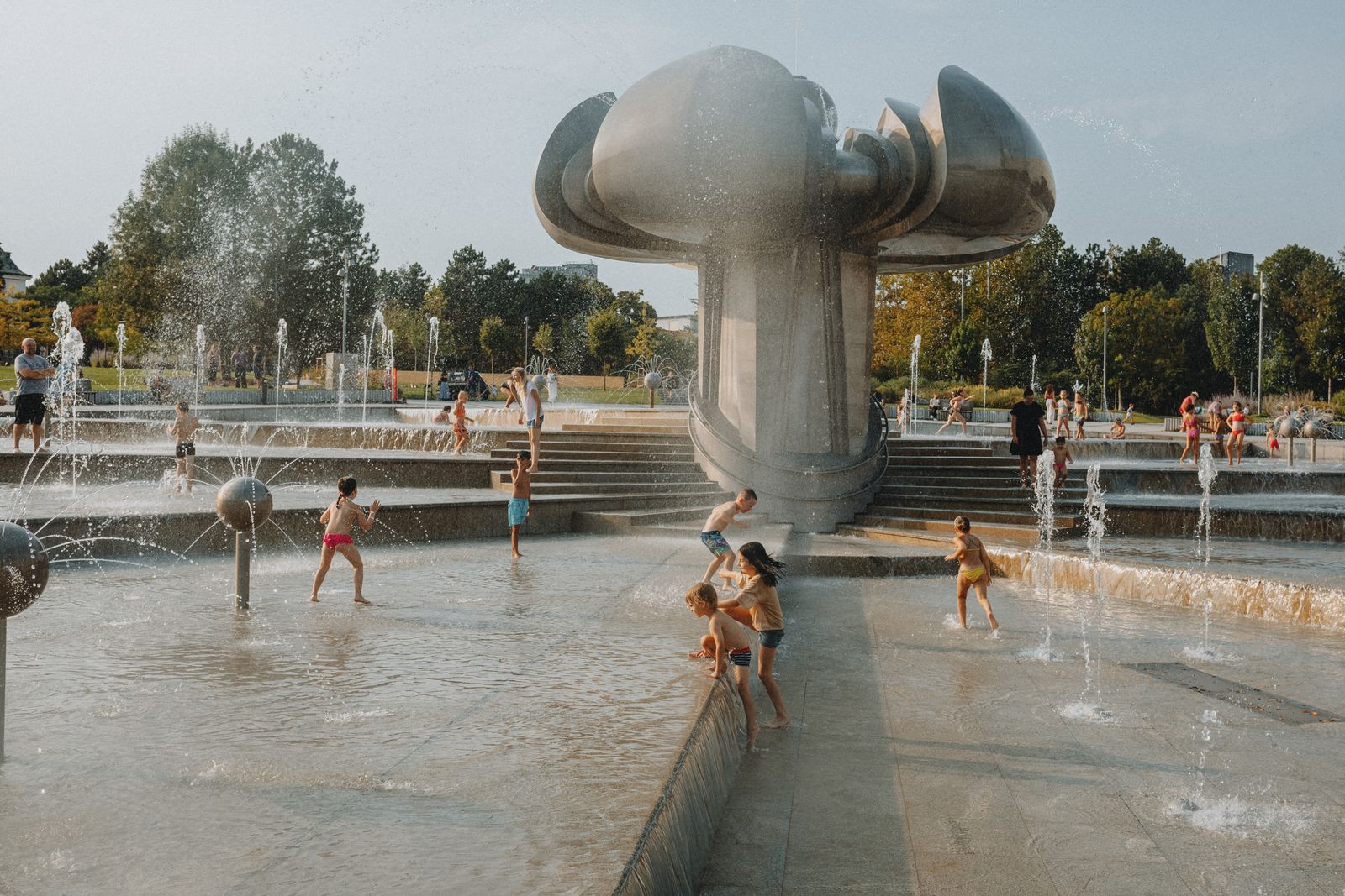 Children cooling off in a summer fountain during a Detroit heat wave